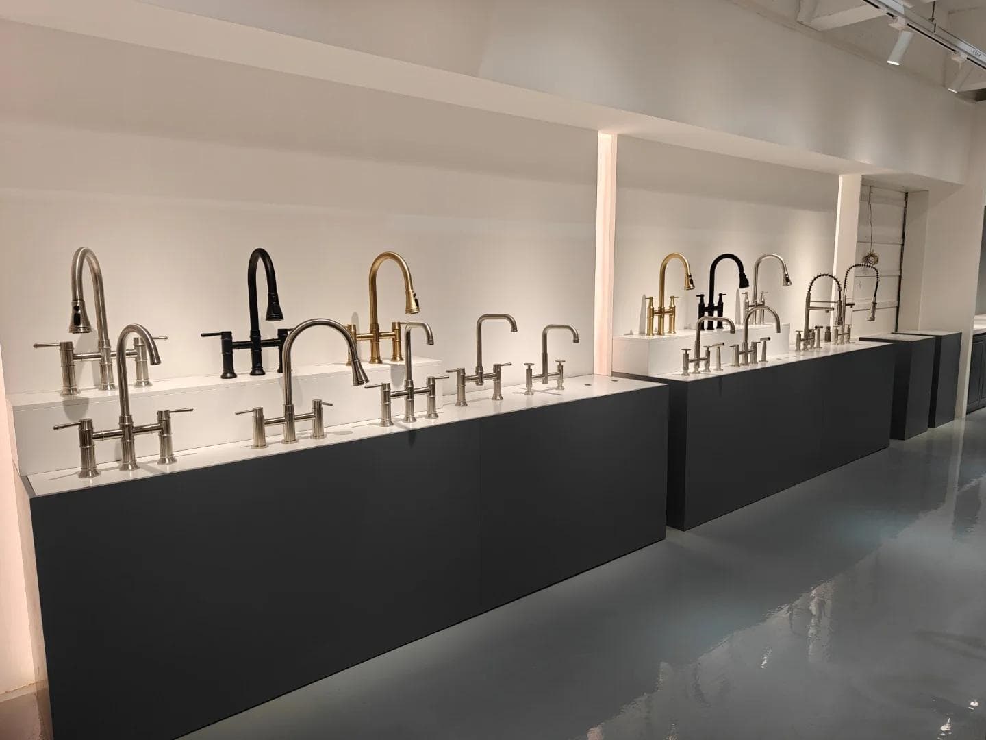 OTTUA showroom displaying kitchen faucet models and finish options for OEM programs